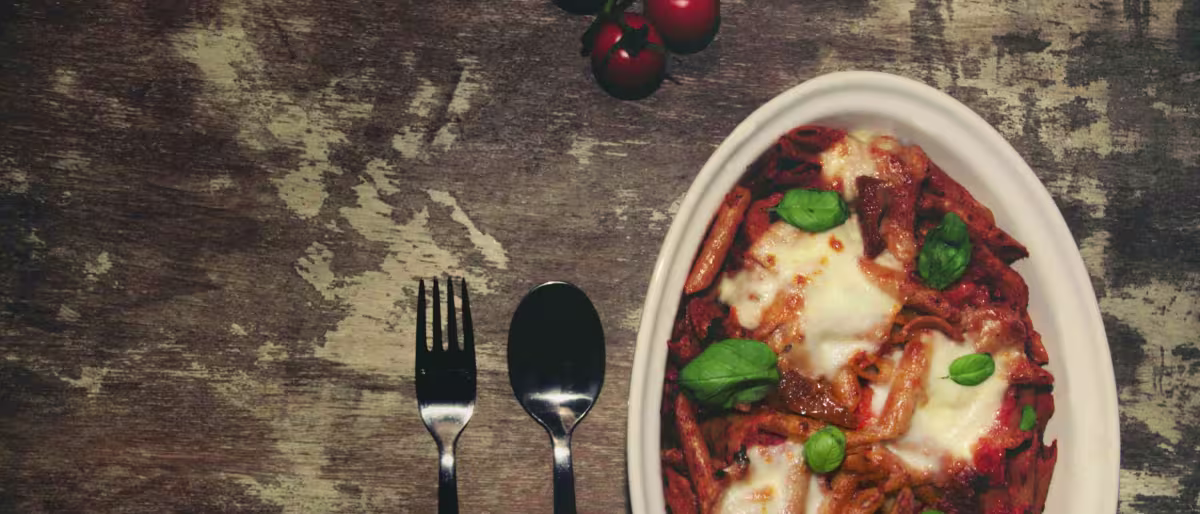 Mouth watering vegetarian pasta bake with rich tomato sauce and cheese toppings